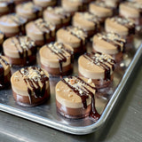 A tray of vegan Peanut Butter and Caramel Cheesecakes